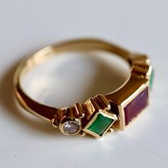 Named in homage to the Italian artist and goldsmith, this design features a garnet, emeralds and 0.11 carats of diamonds accents mounted in a renaissance style setting. 14k gold - available in sizes 5-8. Heirloom Yellow Gold Multi-stone Diamond Ring, Emerald Cut Emerald Ring With Multi-stone Diamond, Emerald-cut Multi-stone Diamond Emerald Ring, Vintage Multi-stone Ruby Ring In 14k Gold, Classic Multi-stone Jewelry For May Birthstone, Yellow Gold Multi-stone Emerald Birthstone Ring, Heirloom Multi-stone Emerald Ring In Gold, Heirloom 14k Gold Emerald Ring With Accent Stones, Heirloom Emerald Ring With Accent Stones In 14k Gold