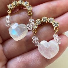 You will adore these handmade rainbow moonstone heart shaped gemstone stud drop earrings with 14K gold filled wire wrapped Herkimer diamonds attached to arched shaped clear crystal cluster earrings! The rainbow blue flash shines brilliantly off these rare faceted heart shaped rainbow Moonstones. They will literally take your breath away. On each side of the heart shaped gemstones are two tiny Herkimer diamond crystals wrapped with 14K gold filled wire.  These beauties would be perfect for your W Crystal Heart Earrings Perfect As A Gift, Heart Shaped Crystal Jewelry For Pierced Ears, Dangle Heart Earrings As Gift, Round Crystal Gemstone Earrings, Dainty Crystal Gemstone Earrings For Gift, Moonstone Crystal Drop Earrings For Gift, Dainty Gemstone Crystal Earrings For Gift, Heart Beads Drop Earrings For Wedding, White Moonstone Crystal Earrings As Gift