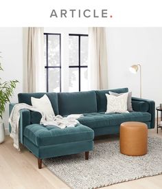 a living room scene with focus on the couch and ottoman, which is also featured in article article