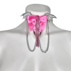 Choose the color elastic, bow, wing, and hardware you want to recreate this look to fit your style! Adjustable neck band. Petal Pink elastic, halo wings, medium pink bow, crystal rhinestones, silver chains, and silver hardware pictured here. Satin Elastic • Adjustable Straps • Hand Wash • Air Dry Pink Party Jewelry With Butterfly Knot Detail, Pink Party Jewelry With Butterfly Knot, Adjustable Pink Jewelry For Cosplay, Pink Bow Jewelry For Party, Pink Party Jewelry With Bow Detail, Pink Ribbon Jewelry For Party, Pink Punk Jewelry For Party, Thigh Garter, Leg Garters