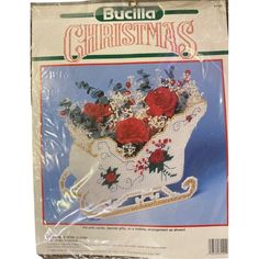 a cross stitch pattern for a christmas sleigh with red roses