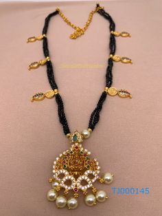 Black Beads Goddess Lakshmi Detachable Pendent NecklaceColor : GoldenSize : Necklace Length : Approx 9 InchesStones : CZ Pearls Black Beads Black Beads With Lakshmi Kasu, Black Beaded Necklace For Diwali, Black Beaded Necklaces For Puja And Festivals, Traditional Black And Gold Beads, Gold Necklace With Black Beads For Puja, Necklace Traditional, Temple Jewelry, Goddess Lakshmi, Pendent Necklace