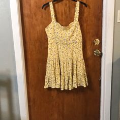 Fun And Flirty Yellow With Blue Floral Print Tiered Skirt Smocked On The Back Ruffle Hem. Fo-Buttons On The Front Great Summer Dress. This Would Look Great With A Jean Jacket. Fully Lined Hidden Left Side Zipper Nwt. Pit To Pit 17 Inches 26 Inches In Length Casual Fitted Sundress With Ruffle Hem, Summer Floral Print Mini Dress, Spring Daywear Mini Skirt Dress, Casual Fitted Sundress With Ruffles, Casual Lined Mini Dress, Floral Print Mini Skirt Dress For Day Out, Forever 21 Fitted Sundress Mini Length, Forever 21 Fitted Mini Sundress, Spring Sundress With Ruffles And Mini Hem