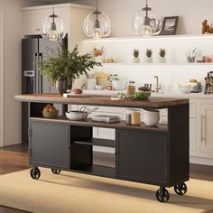 a kitchen with an island and lots of food on wheels in front of the counter