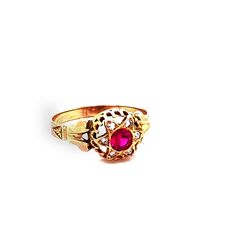 Such an eyecatch! This Victorian era ring is made in lush 18K gold and set with a synthetic red ruby in the center that shimmers in the light. Surrounding that mesmerizing stone is a halo of white diamonds that are pave set and total to .05ctTW. The head of the ring measures 9.41mm long, 9.71mm wide and sits 5.11mm tall. The ring is a size 7 and weighs 1.3DWT. C9168BYVPM --Please reference our policy for more details-- For International orders, please provide a phone number for shipping purposes Heirloom Red Gold Signet Ring, Antique Red 14k Gold Signet Ring, Classic Red Ring With Bezel Setting, Antique Red Signet Ring In 14k Gold, Classic Red Rings With Bezel Setting, Heirloom Yellow Gold Ruby Signet Ring, Classic Red Bezel Set Ring, Heirloom Ruby Signet Ring In Yellow Gold, Formal Red Rings With Bezel Setting