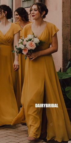 the bridesmaids are walking down the street in their yellow dresses and bouquets