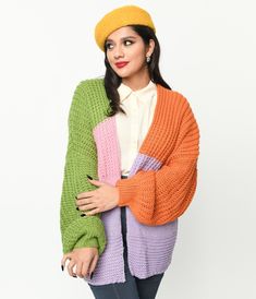 This delightful piece boasts a mesmerizing blend of colors, including green, pink, purple, and orange. Its eye-catching color block design is sure to turn heads wherever you go. Made from a cozy knit fabric, this open cardigan is perfect for both chilly evenings and stylish layering during the day. With its long balloon sleeves adding a touch of whimsy to your outfit, you'll feel like floating on cloud nine!Available in sizes S-L while supplies last. Color Block Design, Purple And Orange, Long Balloons, Cozy Knit, Block Design, Open Cardigan, Eye Catching Colors, Cozy Knits, Balloon Sleeves