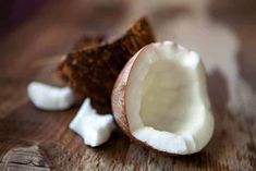 a half eaten coconut sitting on top of a wooden table