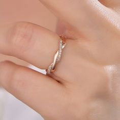 a woman's hand with a diamond ring on top of her left hand,