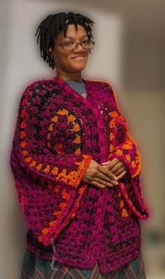 a woman wearing glasses and a crocheted shawl