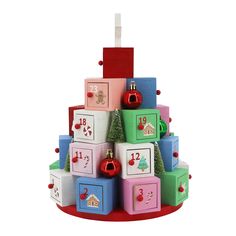 a christmas tree made out of blocks with ornaments on top and numbers on the sides