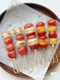 a plate topped with ketchup cats on skewers next to other food items