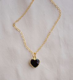 "Crafted onto a 14k gold filled chain and set in 24k gold electroplate, this black onyx heart is as precious as the affection it symbolizes. Make it that perfect gift for someone special, including yourself! Exuding protective and calming energies, Black Onyx is associated with the root chakra. It's believed to be an \"anti-panic\" stone which soothes stress and helps clear mental confusion and hyperactivity. GEMSTONE: Black Onyx STONE SIZE: average 10mm (.39\")  STONE SHAPE: Faceted Heart (Hear Black Gold-plated Adjustable Chain Jewelry, Black Personalized Pendant Necklaces, Black Tarnish-resistant Charm Necklace As Gift, Personalized Black Pendant Necklaces, Elegant Black Personalized Necklace, Black Enamel Necklace For Anniversary, Gold Plated Black Jewelry For Gift, Gold Onyx Jewelry For Gift, Black Pendant Jewelry For Anniversary