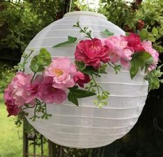 a white paper lantern with pink flowers on it