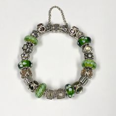 Pandora Green/Silver Completed Charm Bracelet In Excellent, Pre-Owned Condition All Of The Beads Are Retired/Discontinued. Circa Mid 2000s (2007-2008). Bracelet Was Probably Worn Less Than 5 Times Hence The Clean Condition. Retail Was Well Over $1,000 With All The Beads To Build. - 20 Beads Total - 2 Sterling Silver Clips - 1 Snake Chain Moments Bracelet - 1 Safety Chain 8.25” Overall Length With Beads Attached 2.5” Length For Safety Chain Green Pandora Bracelet, Pandora Green, Jewelry Pandora, Handmade Jewelry Tutorials, Safety Chain, Pandora Bracelet, Green Aesthetic, Jewelry Tutorials, Snake Chain