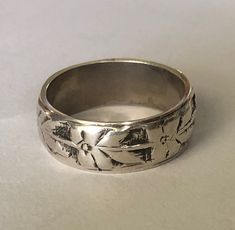 Vintage artisan crafted, hand forged sterling silver band ring.  This one has been well loved, and the pattern has softened with aged.  There is not sterling hallmark, but I have acid tested this ring and it is authentic.  It looks to me like a southwestern Native American made piece.  Would make a  beautiful wedding band, thumb ring for her or just a great everyday ring.  Very pretty and distinctive. Size 12.  9 grams silver.  8.5mm wide. To see all of my rings: https://www.etsy.com/shop/DamselFarmVintage?section_id=35471969 I sell vintage items but do not list anything (knowingly) that is overly worn or damaged.  Happy customers are important to me so please contact me with any issues that might come up with your order. Shipping overages for combined orders will be refunded. This item is Mens Sterling Silver Rings, Vintage Mens Ring, Weird Rings, Wide Silver Ring, Beautiful Wedding Bands, Jewelry Mens, Wide Band Ring, Everyday Ring, Motif Vintage