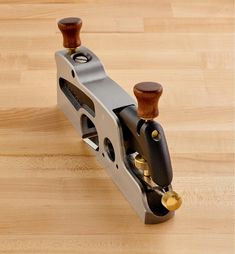 a pair of wood and metal pedals sitting on top of a wooden floor