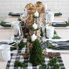 the table is set with place settings, napkins, and candles for an elegant look