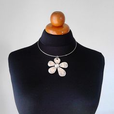 Beautiful minimalist necklace made with a gorgeous flower brass pendant, nickel free. It is a stunning piece, perfect to make everyone's attention turned on you. Choker included ! Contains no lead or nickel. Do not perfume over it or subject it to any liquid substances. I love the pure metal. But over time, metal will darken slightly, but when you rub stationery eraser, brilliance will return. Composition: I always use natural materials, in this case real brass. The materials I use, are made from a small local traditional company. They use natural products such as cotton, silk and viscose and they love colors. The materials are really expensive here compared with them are made in others country but they are ecological, skin friendly, they don't fade and they have very good resistance. Τhei Metal Flower Charm Necklaces, Spring Choker Jewelry Gift, Spring Flower Choker Necklace As Gift, Spring Flower Choker Necklace For Gift, Spring Gift Choker Jewelry, White Flower Metal Necklaces, White Flower Metal Necklace, White Metal Flower Necklace, Silver Necklaces With Flower Charm For Spring