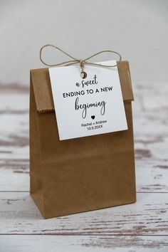 a small brown bag with a tag on it that says, sweet ending to a new beginning