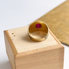 Estate/ vintage 14KT yellow Gold Byzantine/ Etruscan design polished + textured matte finish cigar band ring with genuine ruby. Elegant, old world piece with faceted, oval-shaped, cabochon, genuine red ruby. Ruby measures: 8mm x 5.7mm Size 7 Can be sized by your local jeweler or ours for a fee Solid Measures: 13.6mm wide~ graduated back to 3.5mm Weight: 4.6 grams Excellent condition Vintage Oval Dome Ring As A Gift, Formal Ruby Signet Ring, Vintage Oval Dome Ring Gift, Ruby Signet Ring With Bezel Setting For Formal Occasions, Oval Engraved Ruby Ring Gift, Heirloom Ruby Signet Ring With Polished Finish, Heirloom Style Dome Ring With Cabochon For Gift, Heirloom Dome Ring With Cabochon For Gift, Luxury Engraved Oval Ruby Ring