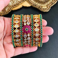 2.6 Bridal Golden Multicolor CZ bangles/Sabyasachi American diamond ruby emerald bangles Set/CZ American diamond bangles@AryaFashions Features Traditional American diamond bangles Set Handcrafted To Perfection Light Weight Perfect For Indian Weddings And Celebrations A Beautiful & Memorable Gift for Weddings and Special Occasions Includes 4 Green Bangles, Pair of Golden Bangles with Pink Flowers and Pair of Golden White stones in each set. Picture shows combination of 7 bangles. Comes in pai Multicolor Wedding Bangle With 17 Jewels, Ruby Emerald Bangles, Emerald Bangles, Green Bangles, Indian Wedding Jewellery, Golden Bangles, Cz Bangles, Kanjivaram Sarees Silk, Kundan Bangles