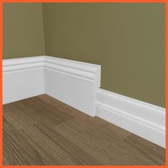 the corner of a room with wood flooring and white mold moulder trim