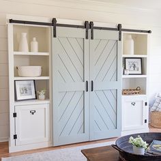 a living room with two sliding doors and a coffee table in front of the door