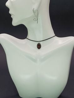 "This exquisite pendant featuring carnelian set in sterling silver indeed embodies both elegance and a vibrant energy. Carnelian, known for its deep, rich hues ranging from orange to reddish-brown, has been cherished through the ages, not only for its beauty but also for its supposed healing properties and ability to inspire courage and creativity. The choice of sterling silver for the frame enhances the warm glow of the carnelian, creating a striking contrast that highlights the stone's natural beauty. This piece of jewelry goes beyond mere adornment; it serves as a talisman of positivity and style. Its timeless design ensures it will be a cherished part of any collection, appealing to those who appreciate the deeper meaning and history behind their accessories.  Note: Keep in mind that t Adjustable Choker Necklace With Large Pendant, Spiritual Brown Oval Pendant Jewelry, Brown Sterling Silver Round Pendant Necklace, Sterling Silver Brown Round Pendant Necklace, Black Choker With Lobster Clasp As Gift, Nickel-free Black Choker As A Gift, Elegant Nickel-free Necklace With Oval Pendant, Elegant Nickel-free Oval Pendant Necklace, Minimalist Adjustable Oval Necklaces