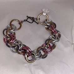 9 1/4" Large Chain Mail Bracelet. This Features Anodized Aluminum Links In The Colors Of Silver, Gunmetal, Brass, And Pink. There Is A Pewter Toggle Used As A Closure. I Can Make This Longer Or Shorter Upon Request. Nickel-free Metal Chain Link Bracelet, Metal Bracelets With Jump Ring For Jewelry Making, Nickel-free Metal Chain Link Charm Bracelet, Nickel Free Multicolor Metal Bracelets, Metal Link Bracelets With Jump Ring, Silver Chainmail Metal Jewelry, Metal Chainmail Bracelet Jewelry, Multicolor Nickel Free Metal Bracelets, Silver Metal Chainmail Jewelry