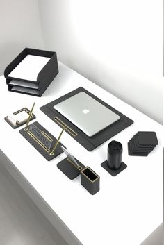 a white table topped with black and gold items