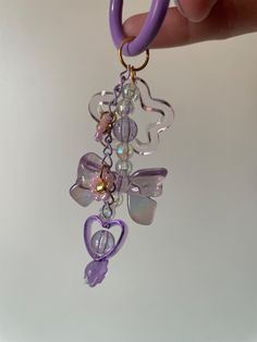 Add a sprinkle of whimsy to your daily essentials with this Fairycore-Inspired Keychain. Adorned with iridescent beads and a charming purple heart charm, it's perfect for those enchanted by the natural world and the realm of fairies. Each piece is carefully curated to bring a touch of magic to your life. Cheap Purple Charm Jewelry, Cheap Purple Jewelry With Charms, Purple Keychain Set, Preppy Keychain, Ocean Fairy, Purple Keychain, Coquette Kawaii, Pearl Ribbon, Purple Cute