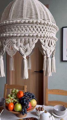 a table topped with fruit covered in tassels