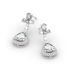 Celebrate one of the most unforgettable moments of your life with this joyous expression of love. Crafted in sterling silver, each earring features a pear-cut center stone wrapped in a halo of shimmering round stones, which shows a really exquisite look. Glittering in bold brilliance, additional stones add more sparkle. Treat yourself or surprise her with this masterpiece.Carat Weight: 6.982 ctStone Size: 2,1,2*3,3*5,6*8 mmStone Type: Jeulia® StoneNumber of Stones: 60 Stone Shape: Round, PearSto Formal Sterling Silver Bridal Earrings With Pear Shape, Pear-shaped Sterling Silver Bridal Earrings For Formal Events, Pear-shaped Sterling Silver Bridal Earrings For Formal Occasions, Fine Jewelry Pear Teardrop Earrings For Anniversary, Fine Jewelry Pear-shaped Teardrop Earrings For Anniversary, Diamond White Pear Shaped Teardrop Earrings For Anniversary, Elegant Cluster Earrings With Halo Setting For Anniversary, Pear-shaped Diamond White Teardrop Earrings For Anniversary, Silver Pear-shaped Bridal Earrings Fine Jewelry