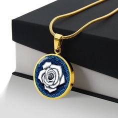 White Rose Circle Pendant Necklace If you're looking for a unique and meaningful gift for your loved one, consider the White Rose Circle Pendant Necklace. While red roses are commonly associated with love, white roses have their own symbolic meaning. In addition to love, white roses are also associated with feelings of affection, purity, innocence, spirituality, and loyalty. The patent-pending jewelry is made of high-quality surgical steel with a shatterproof liquid glass coating, and we have an Rose Necklace With Rose Design For Gift, White Jewelry With Rose Design As Gift, White Jewelry With Rose Design For Gift, White Rose Design Necklace As Gift, White Rose Design Necklace For Gift, Valentine's Day Round Jewelry With Rose Design, Valentine's Day Rose Jewelry Gift, Rose-colored Rose Design Round Necklaces, Mother's Day Rose Necklaces Gift