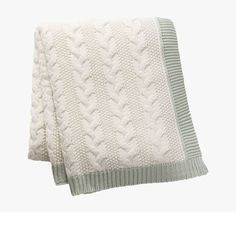 two white knitted blankets folded on top of each other