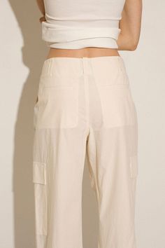 Loosely tailored cargo pant in a soft yet structured cotton. Straight leg with tie at ankle, cinch for a more tapered silhouette. Side pockets and oversized patch pockets above knee. Made in New York City. Fabric is 100% cotton. Ella is 6' tall, 35" bust, 26" waist, 36" hip, and is wearing a size S. Utility Cargo Shorts With Side Pockets For Workwear, Utility Cargo Shorts With Patch Pockets For Workwear, Spring Workwear Cargo Shorts With Side Pockets, Spring Cargo Shorts For Workwear With Side Pockets, Ankle-length Cotton Cargo Pants With Multiple Pockets, Cotton Ankle-length Cargo Pants With Multiple Pockets, Cotton Cargo Pants With Multiple Pockets, Utility Cargo Shorts With Pockets For Work, Spring High-waisted Cargo Pants With Pockets