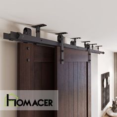 the interior of a house with wooden doors and black hardware on the sliding barn door