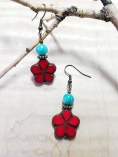 18mm red/travertine Czech table cut Hawaiian flower. 6mm teal shell rounds. 6mm antique bronze corrugated rondelles. Antique bronze fishhook ear wires. Nickel-free Czech Glass Flower Jewelry, Adjustable Red Flower Earrings With Ear Wire, Vintage Red Flower Shaped Jewelry, Red Bohemian Jewelry With Flower Charm, Adjustable Red Jewelry With Flower Charm, Red Dangle Jewelry With French Hook, Red Round Jewelry With Flower Charm, Nickel-free Red Flower Jewelry, Adjustable Nickel-free Red Flower Earrings