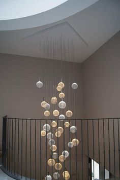 a large chandelier hanging from the ceiling in a room with metal railings