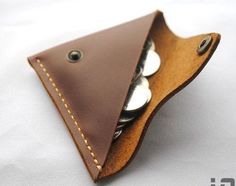 a brown leather wallet with coins in it