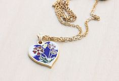 "This is a very sweet, vintage necklace from the 70s. It is 14K Gold Plated. The charm is about 15mm wide and is made with enamel. The chain is 16\" long. There are other colors available so check the store! --Shop Policies-- Please be sure to read our shop policies before making your purchase. Thank you! https://www.etsy.com/shop/diamentdesigns/policy" Vintage Heart Enamel Necklaces, Vintage Enamel Heart Necklaces, Blue Enamel Necklace For Anniversary, Vintage Heart Enamel Necklace, Vintage Blue Enamel Necklace, Vintage Enamel Heart Necklace, Vintage Heart-shaped Enamel Jewelry, Blue Heart Necklace, Blue Flower Necklace