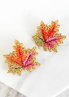 Get ready to FALL in love with Dos Femmes' one-of-a-kind Maple Leaf Earrings. These stud earrings are bursting with bold, vibrant colors that are sure to elevate your style for the rest of the year. Made with 14 karat gold plated studs and hypoallergenic materials, wear them all fall and winter long to add a touch of quirky charm to your outfit. Measuring 2.00" from top to bottom, these handcrafted earrings are lightweight and unique, exclusive to Dos Femmes. Vibrant Handmade Gold Earrings, Handmade Vibrant Gold Earrings, Handmade Multicolor Jewelry For Fall, Handcrafted Earrings, Months In A Year, Leaf Earrings, Hand Beading, Fall And Winter, Maple Leaf