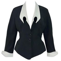 Incredible rare Thierry Mugler black jacket with a dramatic pointed white collar and matching white cuffs from the Spring Summer 1992 collection and as seen on the runway. Made in France Fitted waist, pointed cuffs Closes with two snap buttons Size: FR38 Condition: In excellent condition with no noticeable flaws Measurements: Shoulders- 32” Bust- 34” Waist- 28” Length- 24” Sleeve Length- 22” Mugler Black, Black Runway, White Blazers, Shoulder Jacket, Thierry Mugler, Vintage Jacket, White Collar, Black Jacket, Primavera Estate