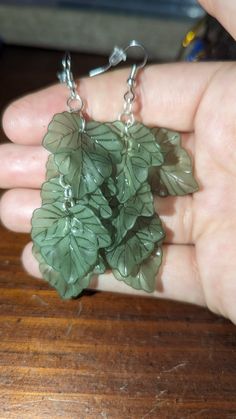 These lovely earrings would be an amazing addition to anyone's jewelry collection! Green Leaf-shaped Sterling Silver Earrings, Mythical Aesthetic, Cottage Outfits, Bog Witch, Green Jewellery, Wire Wrapped Jewelry Diy, Earthy Style, Pole Wear, Magical Jewelry