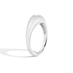 a white gold ring with three diamonds on the top and bottom, set in 18k white gold