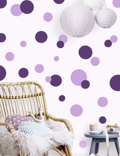 purple and white polka dot wallpaper in a child's room with wicker chair