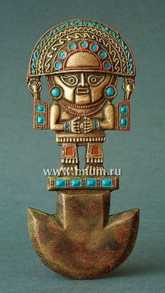 an old bronze figurine with blue and gold decorations on it's head