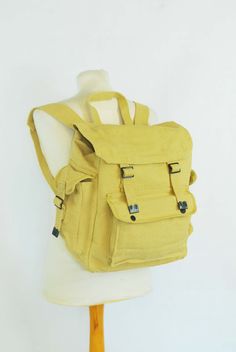 "100% Cotton Canvas Rucksack/Backpack - Various Colours Yellow - Blue - Khaki - Black Features: 1 x main front compartment 1 x front storage pocket 2 x side pockets Adjustable metal buckled straps and front fastenings. Easily fits a laptop Great for school, college, camping or simple everyday use Thick canvas cotton material Strong and well made product Ex-military Max capacity dimensions: 15\" x 15\" x 8.5\" (XL rucksack, fits all laptop sizes) Fabric: 100% thick cotton canvas. Condition: The c Functional Yellow Backpack With Adjustable Strap, Outdoor Backpack With Pockets, Outdoor Backpack With Side Pockets, Outdoor Activities Backpack With Side Pockets, Outdoor Activities Standard Backpack With Side Pockets, Functional Adventure Bags With Adjustable Straps, Outdoor Activities Satchel Backpack With Pockets, Back To School Satchel Backpack With Pockets, School Backpack With Multiple Pockets