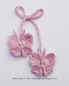 two pink crocheted flowers tied together